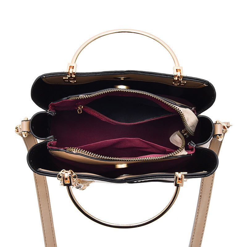 Dwukolorowa torebka ze złotymi uchwytami i serduszkiem